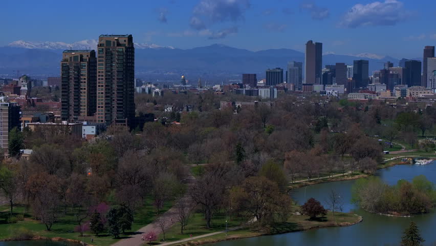 Downtown Denver City Park Colorado aerial drone Pavillon springtime summer tree wildflower blossom sunny morning blue sky Ferril Duck Lake bike walking path tall buildings skyscrapers pan right motion