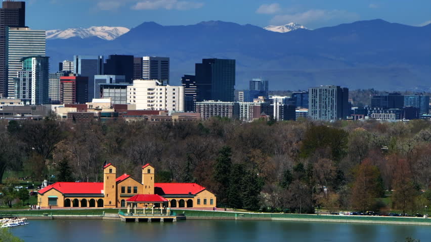Downtown Denver City Park Pavillon building Colorado aerial drone springtime summer tree wildflower blossom sunny morning blue sky Ferril Duck Lake bike walking path tall skyscrapers pan left motion