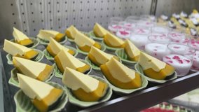 Assorted Thai desserts with egg custard, red rubies in coconut milk, and blueberry cheesecake on display. - Powered by Shutterstock - Get 15% off with code: PIKWIZARD15