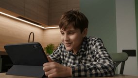 Autistic Boy Engaged in Online Lesson via Tablet. Learning Through Screens. - Powered by Shutterstock - Get 15% off with code: PIKWIZARD15