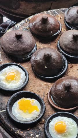 A series of video clips showing the process of making and serving "Banh Can," or Mini Vietnamese Savory Pancakes, a traditional street food in Da Lat, Vietnam.