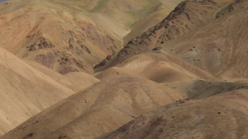 Flickering textured cloud shadows and light over mountainous landscape, Ladakh, India.