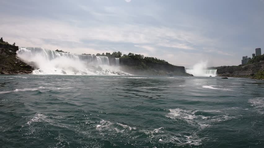 DOLLY SLOW - The American, Bridal Veil, and Horseshoe Falls as seen from the Niagara City Cruises. Niagara Falls is a collective name for a group of three waterfalls situated on the Niagara River.
