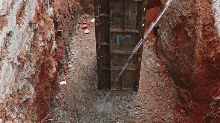 Water curing to the foundation for maintain proper moisture, ensuring strength and durability of the structure. day time, zoom out shot, 4k.
