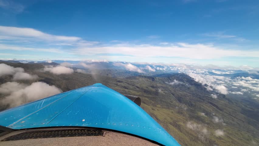 Kodiak airplane flight POV, flying over green mountains in Papua New Guinea