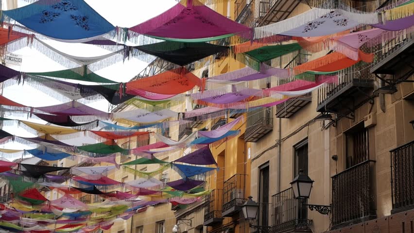Bright Mantones de Manila on display during La Paloma festivities in La Latina, Madrid.