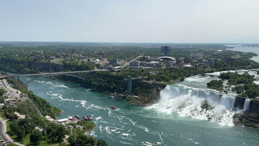 The American Falls and Bridal Veil Falls, the U.S. Customs and Border Protection – Rainbow Bridge Port of Entry, and the Prospect Point Observation Tower in Niagara Falls, Ontario, Canada.