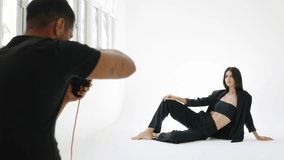 Fashion photographer capturing model posing in slow motion - Powered by Shutterstock - Get 15% off with code: PIKWIZARD15