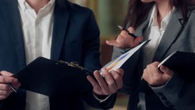 Smiling Caucasian business man boss talking Korean woman worker chart graph finance growth analyzing paperwork documents clipboard happy businessman businesswoman speaking agents strategy at office - Powered by Shutterstock - Get 15% off with code: PIKWIZARD15