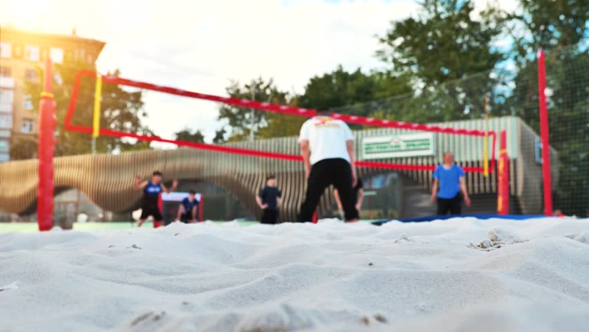 Enthusiastic Group Playing Beach Volleyball Together
