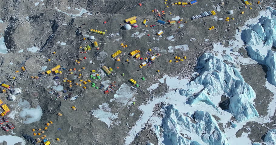 Aerial view of Mount Everest Base Camp Nepal climbers begin summit journey shining snow-capped peaks pristine white Khumbu Glacier, colorful tents, Himalayan landscape adventure nature conservation.