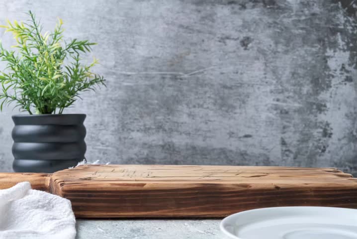 Stop motion animation of chocolate cookies stacking on a plate with glass of cocoa drink, cozy kitchen still life with copy space for text.