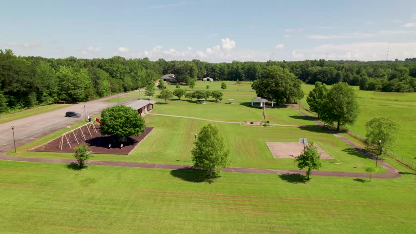 Aerial footage of the Wooster City Park in Wooster Arkansas. Camera flies over the park revealing several park ammenities.