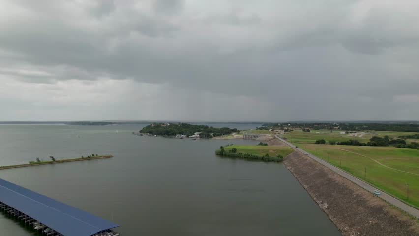 Aerial video of Eagle Mountain Lake. Camera is flying near the Eagle Mountain Lake Marina. Storm clouds and rain can be seen in the distance.