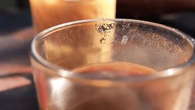 Close up video of a steaming hot coffee cup placed on a wooden table, perfect for café lifestyle, breakfast mood, food and beverage, relaxation and cozy morning vibes. - Powered by Shutterstock - Get 15% off with code: PIKWIZARD15