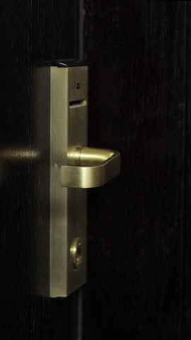 Vertical Video Close up of female hand open hotel room door with electronic card key. Protection and security system concept.