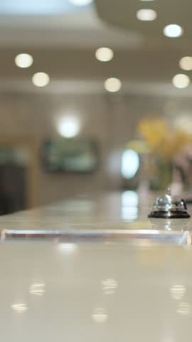 Vertical Video Customer with mobile phone pay for hotel reception, payment. Client, concierge service or people at help desk. Person at reception desk and doing check. Close up.