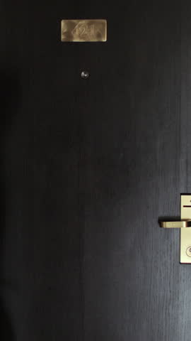 Vertical Video Woman walks into hotel room pulling a suitcase. Perfect for travel, vacation, and hospitality.