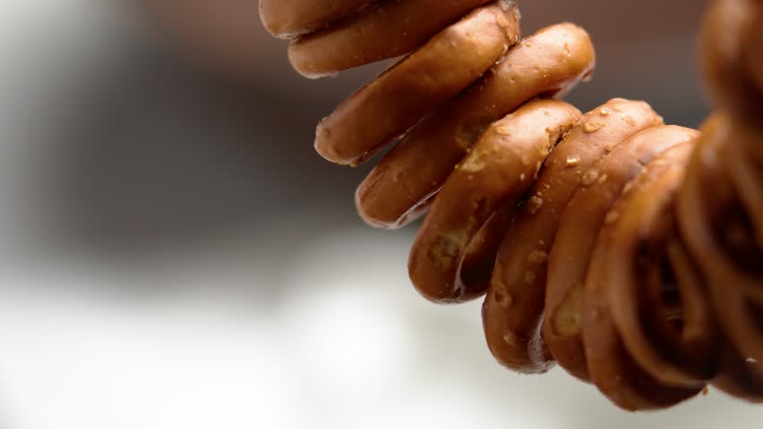 Hanging bunch of salted pretzel crackers. Macro shot