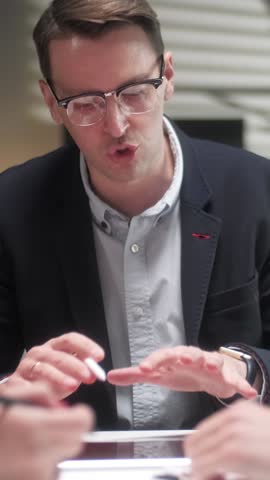 Business people Talking Strategy With Tablet At Office Desk. In Creative Team In Office Productive Coworkers Sitting At The Table For Company Meeting. Teamwork And Social Concepts. Vertical Video