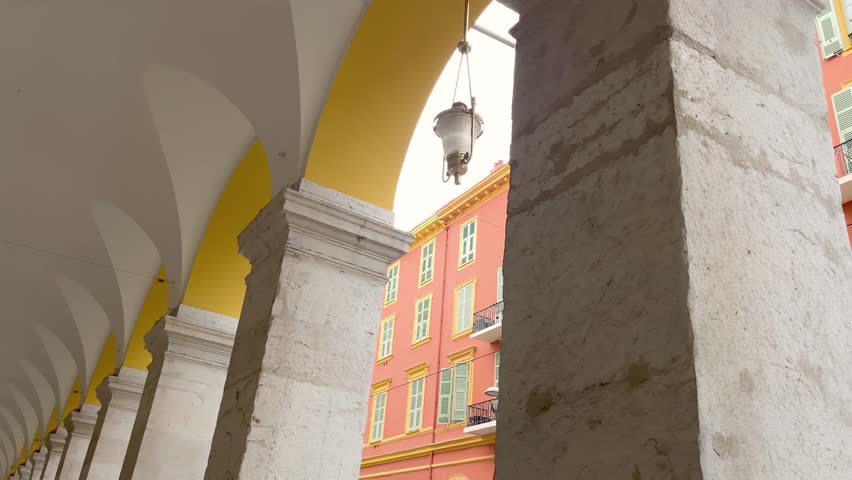 Bottom view of old, traditional street lamp and buildings in famous touristic city called Nice located in French riviera. It shows French architectural style.
