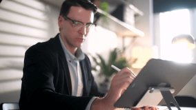 Business Man Engineer Is Working With Blueprints And Laptop In Modern Workplace. Handsome Male is Glasses Working In Modern Office Interior Work Place, Looking Concentrated And Confident Became - Powered by Shutterstock - Get 15% off with code: PIKWIZARD15