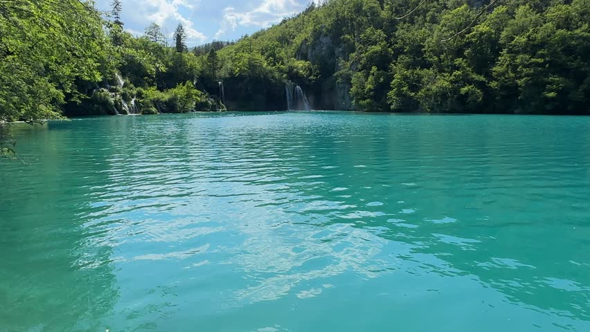 Experience the stunning beauty of Plitvice Lakes in Croatia, with its turquoise waters and lush nature. This national park showcases a breathtaking landscape of clear blue lakes and vibrant greenery.