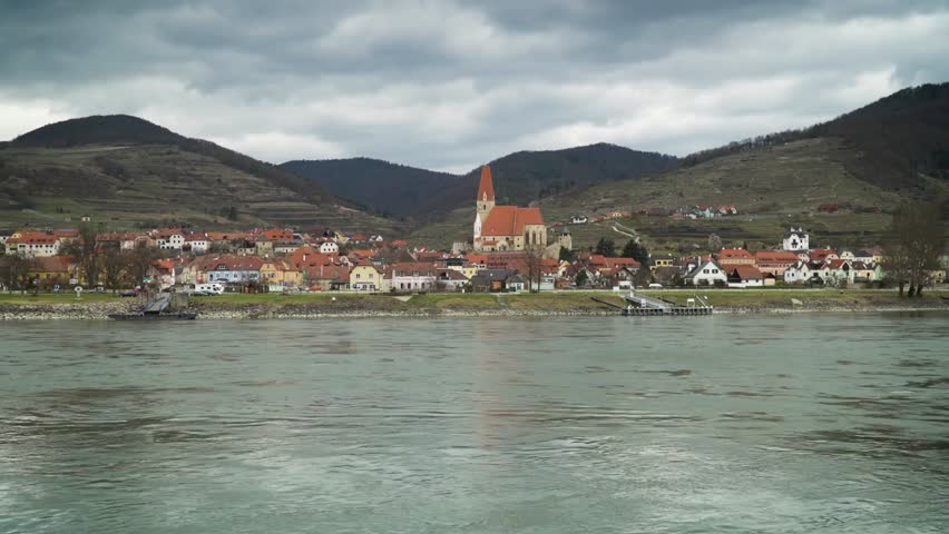 Picturesque view of durnstein village with church along the danube river, austria