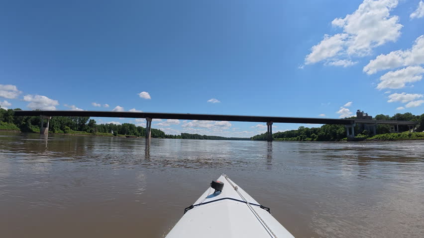 paddling on the Missouri River and approaching highway bridge at Boonville, MO - POV from kayak or canoe