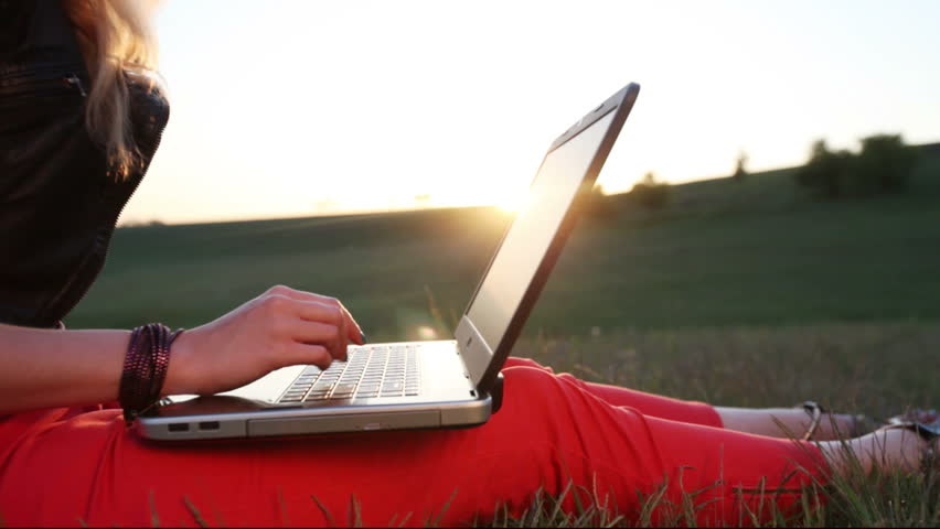 Blonde use laptop, sunset