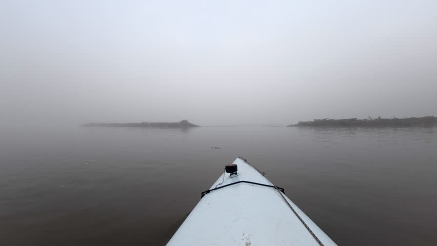 foggy morning paddling on the Missouri River near confluence with Osage River, MO - POV from kayak or canoe