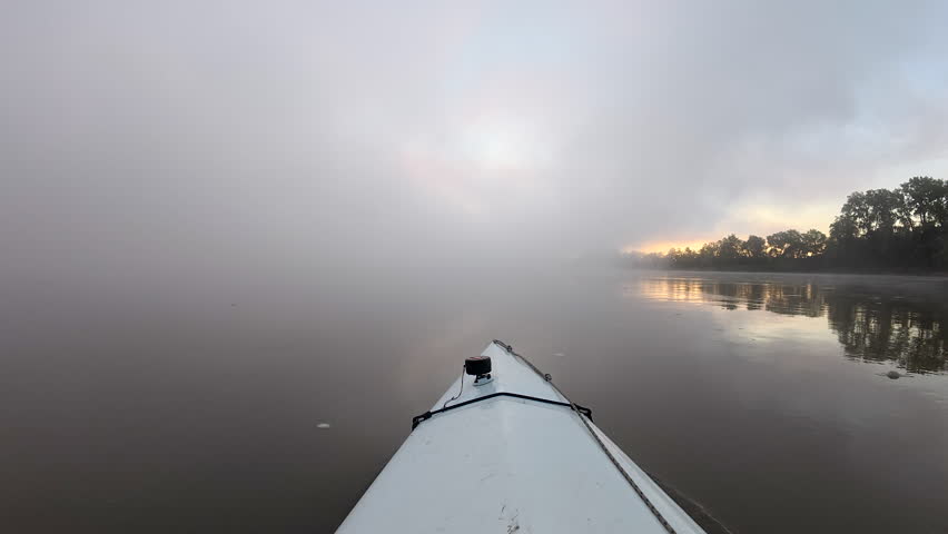 foggy morning paddling on the Missouri River near confluence with Osage River, MO - POV from kayak or canoe