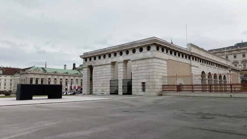 Hofburg palace building in vienna, austria, under a cloudy sky
