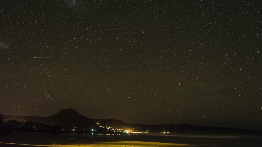 Panoramic view of Christchurch central city, cathedral spire foreground, diffuse midday sun and drifting clouds on a summer afternoon in New Zealand.