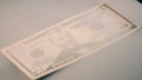 A jet of air makes the smoke to diverge off a fifty dollar bill. Closeup. Macro. Slow mo, slow motion, high speed camera, 200fps - Powered by Shutterstock - Get 15% off with code: PIKWIZARD15