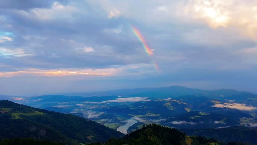 Aerial of a stormy rainbow in the mountains