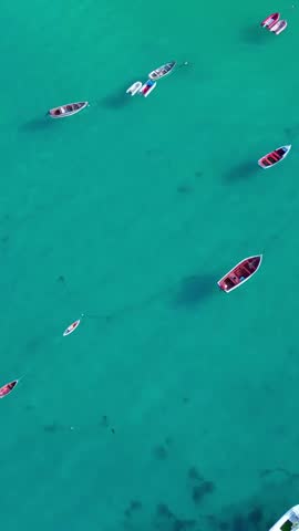 Aerial  video of Santa Maria pier and beach in Sal Island, Cape Verde. Sunset and sunrise colors, turquoise Atlantic waters, boats and tropical landscape in cinematic drone movement.