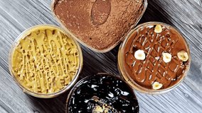 Assorted desserts of Tiramisu ladyfinger pastries (Savoiardi) dipped in coffee, Dark chocolate spread profiterole cream puffs, filled French choux pastry, biscuit and chocolate creamy with cake  - Powered by Shutterstock - Get 15% off with code: PIKWIZARD15