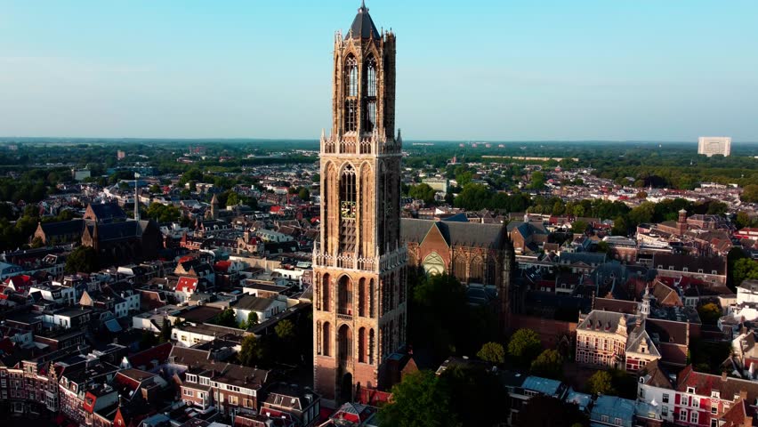 Aerial drone flight over Utrecht, Netherlands. Scenic cityscape with historic architecture, canals, and urban landscape captured from above.