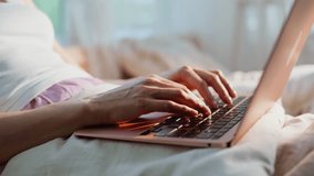 Student hands typing keyboard on white bedding in apartment closeup. Unrecognizable woman freelancer working computer sitting cozy home bed. Relaxed lady surfing internet in bedroom early morning. - Powered by Shutterstock - Get 15% off with code: PIKWIZARD15
