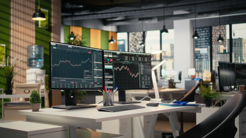 PC monitors displaying stock market candlestick charts in modern prop firm office. Trading company workspace desk setup used for stock exchange analysis and strategy planning - Powered by Shutterstock - Get 15% off with code: PIKWIZARD15