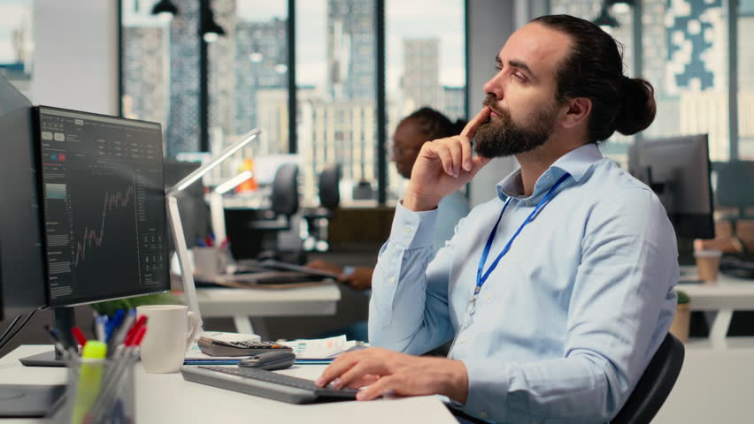 Trader in office doing brainstorming before committing to investment, smiling, expressing trust in choice. Brokerage company expert thinking before trading, showing self assurance, camera B