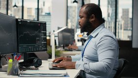 Stressed prop firm employee at work alerted by suspicious hacking alert on trading platform dashboard. Worried african american man in office detects hacking attempt on trading software, camera B - Powered by Shutterstock - Get 15% off with code: PIKWIZARD15