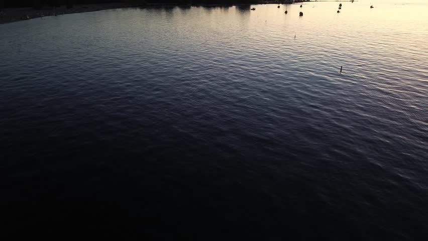 Drone footage of Royal Vancouver Yacht Club at sunset, showing marina, ocean, and golden hour reflections in Vancouver, British Columbia, Canada