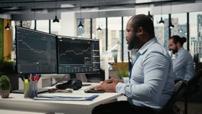 Stressed prop firm employee at work alerted by suspicious hacking alert on trading platform dashboard. Worried african american man in office detects hacking attempt on trading software, camera A - Powered by Shutterstock - Get 15% off with code: PIKWIZARD15