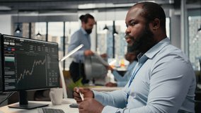 Day trader in brokerage company office analyzes stock market trends and price charts, making buy and sell decisions. Financial expert places client orders using trading software on PC, camera A - Powered by Shutterstock - Get 15% off with code: PIKWIZARD15