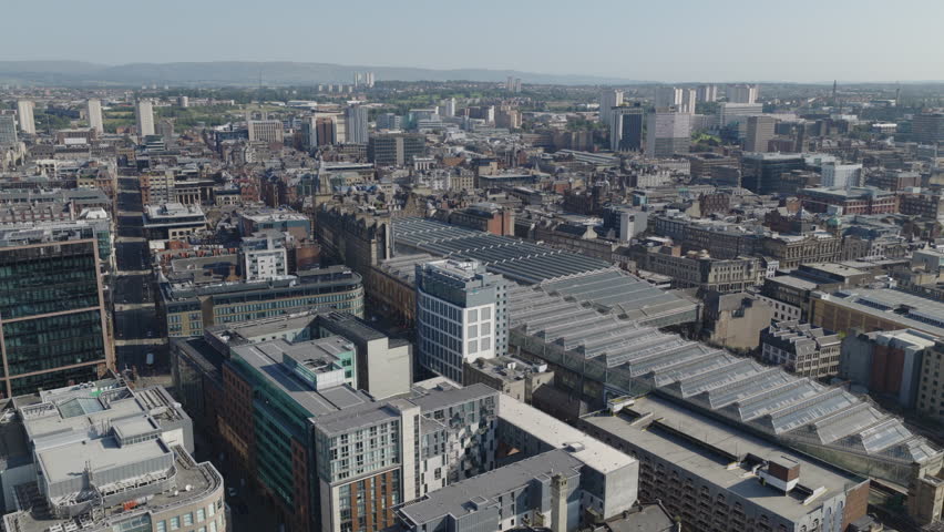 Establishing aerial view of Glasgow, city in Scotland, United Kingdom on bright, sunny day.