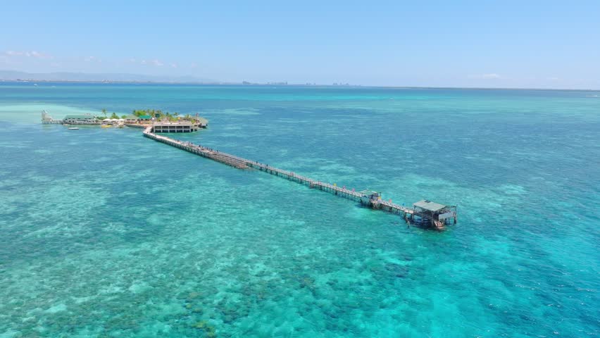 Indulge in a peaceful retreat at this oceanfront resort in Nalusuan Island, Cebu. Immerse yourself in the beauty of coral reefs and turquoise waters. Pure relaxation awaits!
