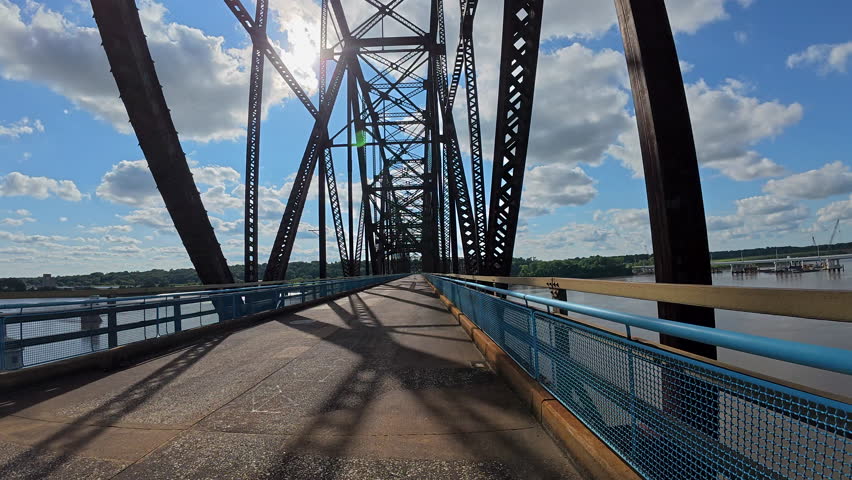 POV cycling across the historic Old Chain of Rocks Bridge (Route 66) over the Mississippi River near St. Louis, Missouri. Scenic ride with sweeping river views, unique bridge design.
