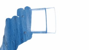 Vertical video. Effervescent drink. Mineral supplement. Blue particles double exposure silhouette of female hand dropping soluble tablet in glass with water isolated on white. - Powered by Shutterstock - Get 15% off with code: PIKWIZARD15